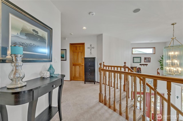 corridor featuring an upstairs landing, recessed lighting, and light colored carpet