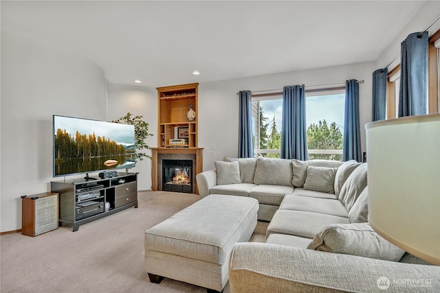 living room with recessed lighting, baseboards, a glass covered fireplace, and carpet flooring