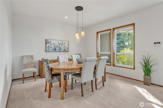 dining room with light carpet, recessed lighting, and baseboards