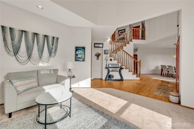 living room with recessed lighting, stairway, baseboards, and wood finished floors