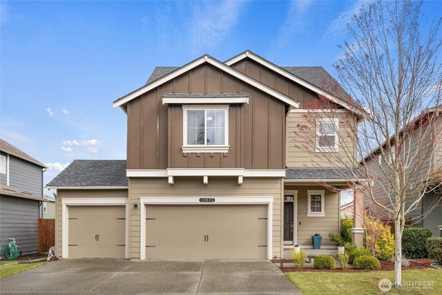 view of front facade with driveway, a shingled roof, a garage, and board and batten siding