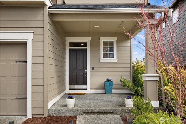 property entrance with a shingled roof