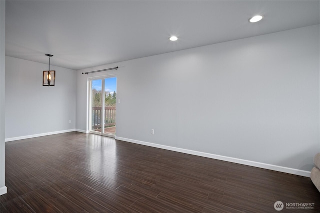 spare room featuring recessed lighting, baseboards, and dark wood-style floors