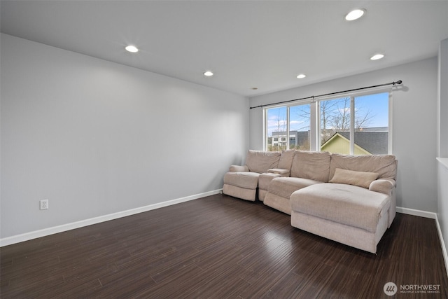 living room featuring recessed lighting, dark wood-type flooring, and baseboards