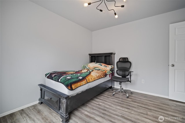 bedroom featuring baseboards and wood finished floors