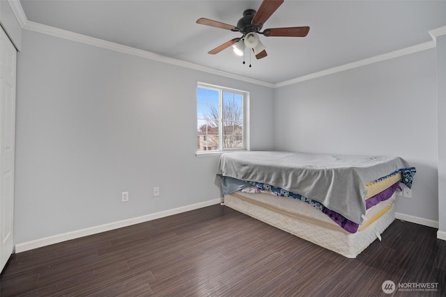 bedroom featuring crown molding, wood finished floors, and baseboards