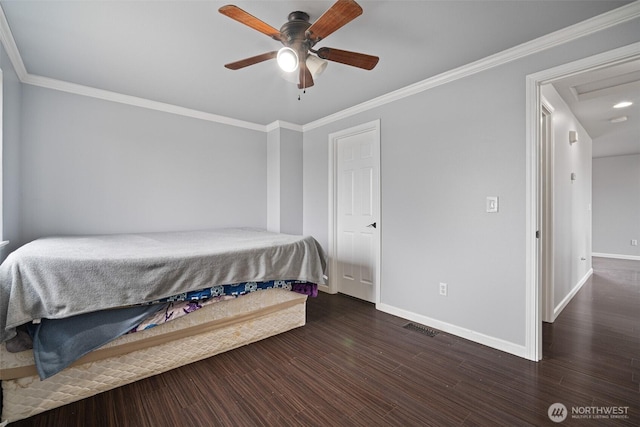 bedroom featuring wood finished floors, baseboards, and ornamental molding