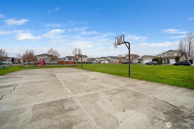 view of basketball court featuring playground community, a residential view, a yard, and community basketball court