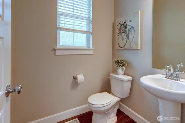 12225 SE 271st Pl, Kent, WA 98030 - half bathroom with toilet, a sink, baseboards, and wood finished floors