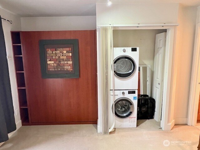 123 Queen Anne Ave N Unit 307, Seattle, WA 98109 - clothes washing area with carpet flooring, stacked washer and dryer, and laundry area