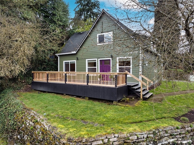 back of property featuring roof with shingles, a yard, and a wooden deck