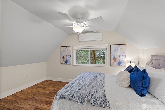 bedroom with vaulted ceiling, baseboards, ceiling fan, a wall mounted air conditioner, and wood finished floors