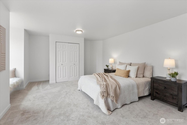 bedroom featuring a closet, baseboards, and carpet