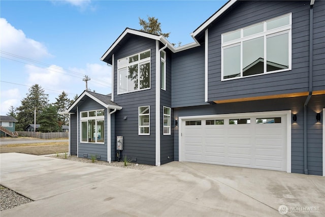 view of front of property with concrete driveway and an attached garage