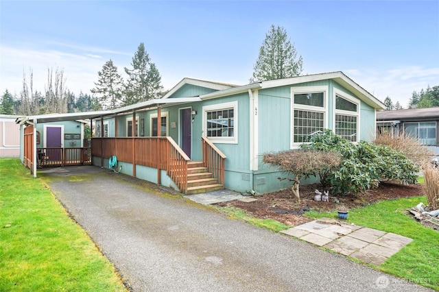 manufactured / mobile home featuring a front lawn, a porch, and crawl space