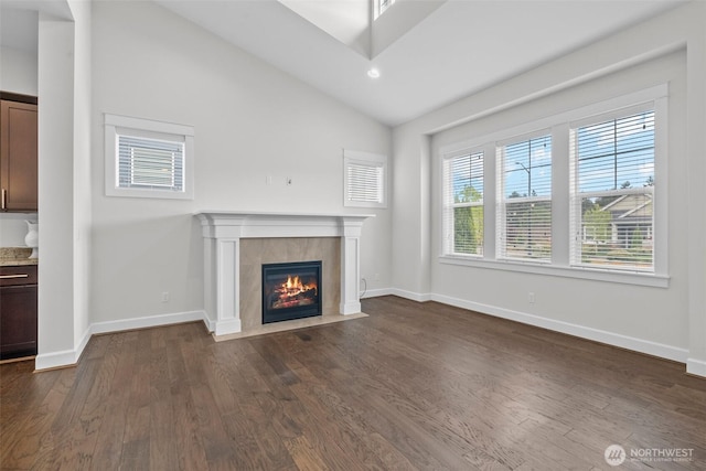 3727 Oakwood St SE, Olympia, WA 98513 - unfurnished living room with dark wood-style floors, a tiled fireplace, baseboards, vaulted ceiling, and recessed lighting