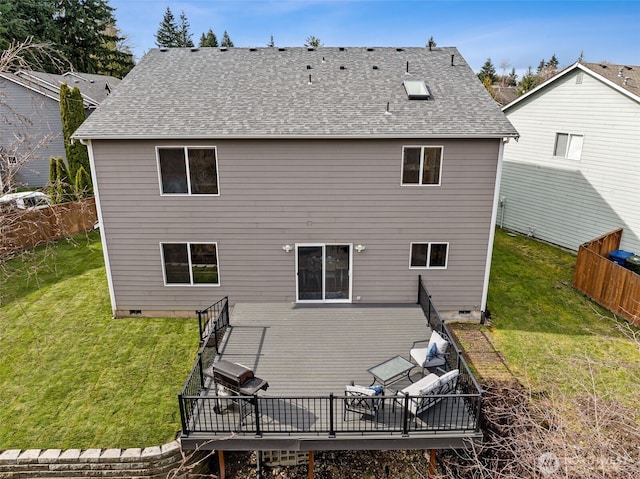 rear view of house with a yard, fence, roof with shingles, and a wooden deck