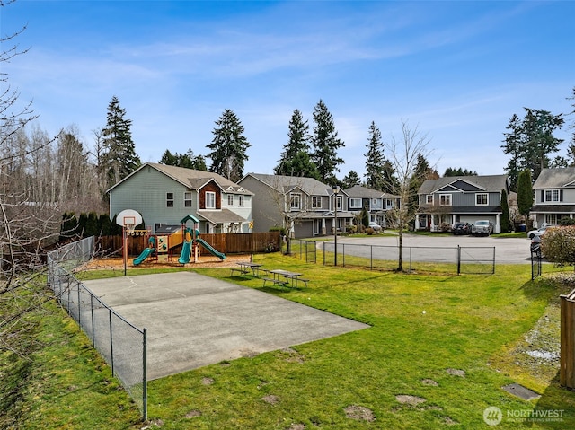 exterior space with a residential view, fence, and a playground