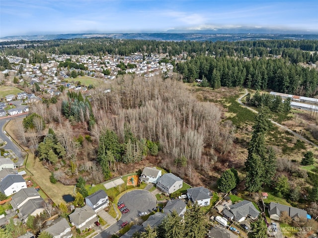 birds eye view of property featuring a residential view and a wooded view