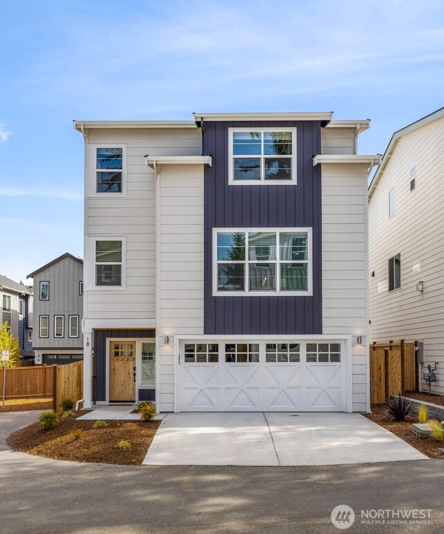 18 160th St SE, Bothell, WA 98012 - contemporary home with driveway, an attached garage, and board and batten siding