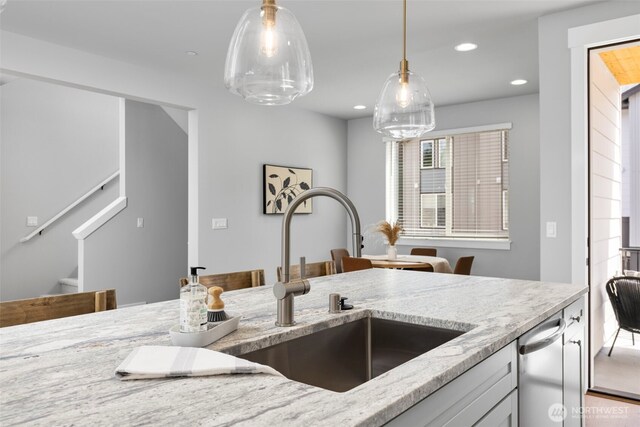 18 160th St SE, Bothell, WA 98012 - kitchen with stainless steel dishwasher, light stone counters, hanging light fixtures, and recessed lighting