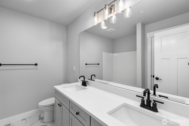 18 160th St SE, Bothell, WA 98012 - bathroom featuring marble look tiles, double vanity, and a shower