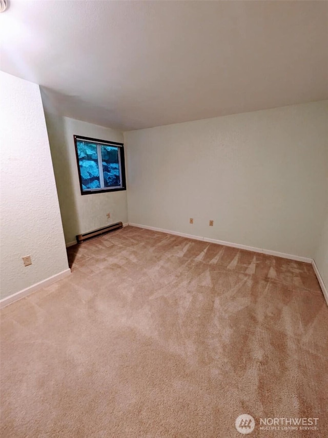 140 Summit Ave N Unit B2, Kent, WA 98030 - empty room featuring a baseboard radiator, light carpet, and baseboards