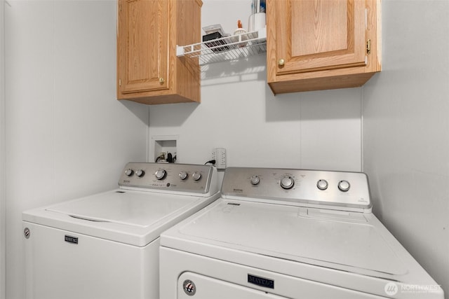 laundry area with washer and clothes dryer and cabinet space