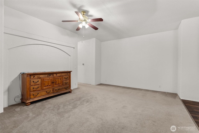 unfurnished bedroom with a ceiling fan and carpet flooring