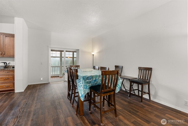 dining room with dark wood-type flooring and baseboards