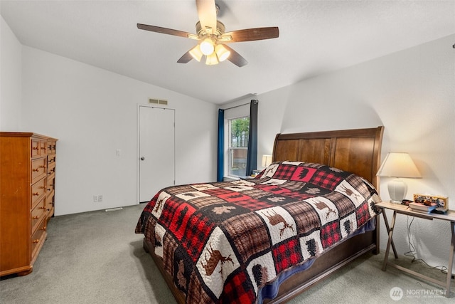 bedroom with visible vents, a ceiling fan, carpet flooring, and vaulted ceiling