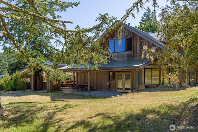 631 Cousins Rd, Lopez Island, WA 98261 - back of house with a patio, a standing seam roof, french doors, a lawn, and metal roof