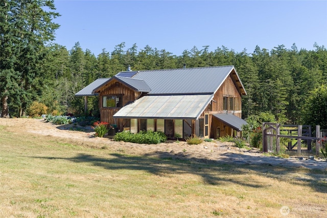 631 Cousins Rd, Lopez Island, WA 98261 - view of front facade featuring a forest view, metal roof, a front yard, and an outdoor structure