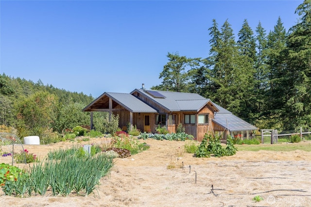 631 Cousins Rd, Lopez Island, WA 98261 - view of front of home featuring an outbuilding, solar panels, metal roof, and a greenhouse