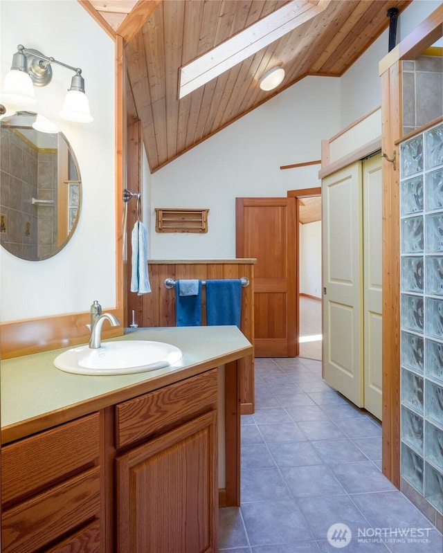 631 Cousins Rd, Lopez Island, WA 98261 - full bathroom with tile patterned floors, vaulted ceiling with skylight, wood ceiling, and vanity