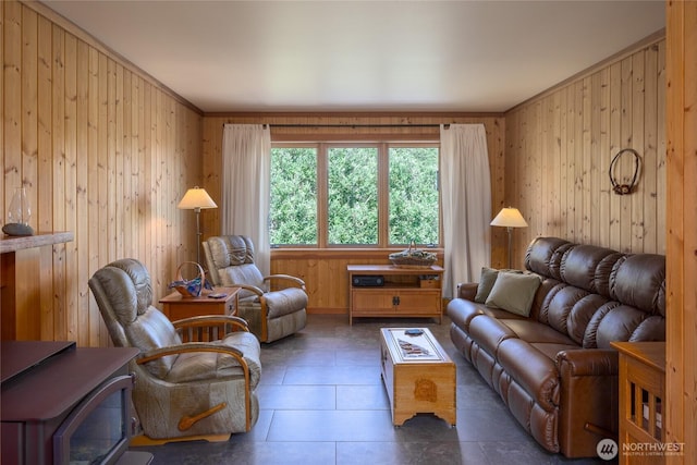 631 Cousins Rd, Lopez Island, WA 98261 - living area with a wood stove, wooden walls, crown molding, and tile patterned flooring