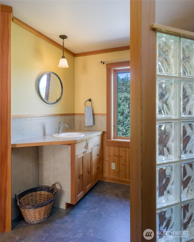 631 Cousins Rd, Lopez Island, WA 98261 - bathroom featuring vanity, crown molding, and wainscoting