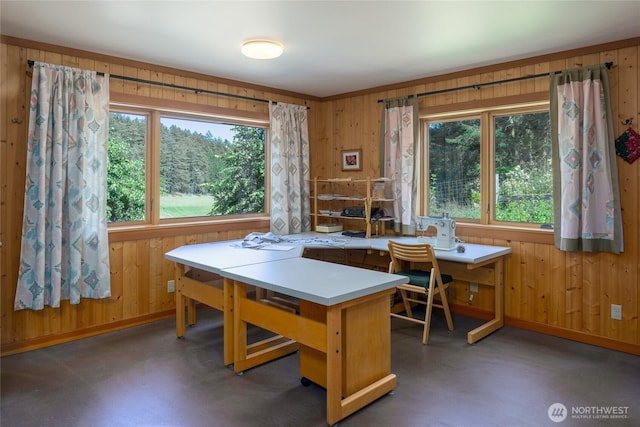631 Cousins Rd, Lopez Island, WA 98261 - dining room with finished concrete floors, wood walls, and baseboards
