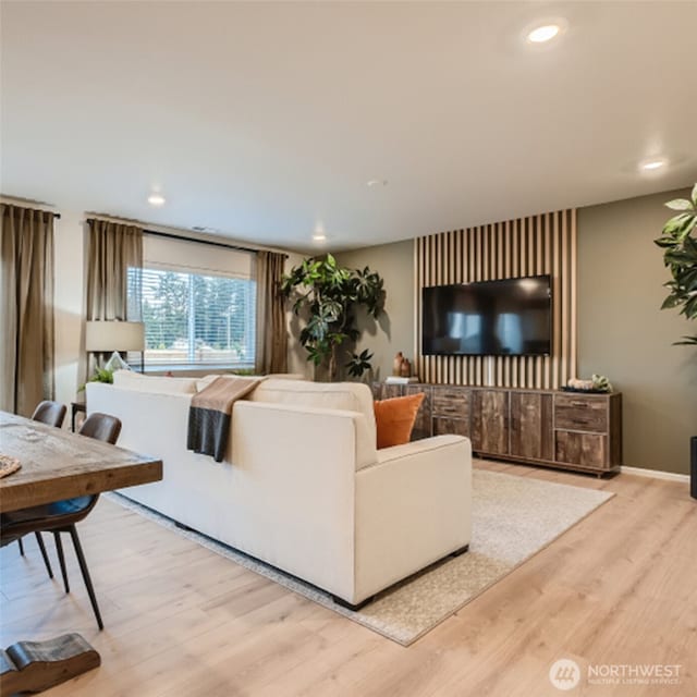 living room featuring recessed lighting, wood finished floors, and baseboards