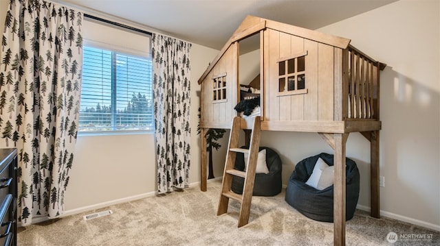 bedroom featuring visible vents, baseboards, and light colored carpet