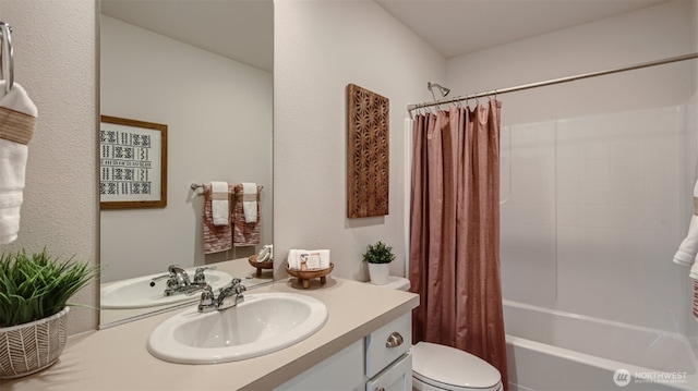 bathroom featuring shower / tub combo with curtain, toilet, and vanity