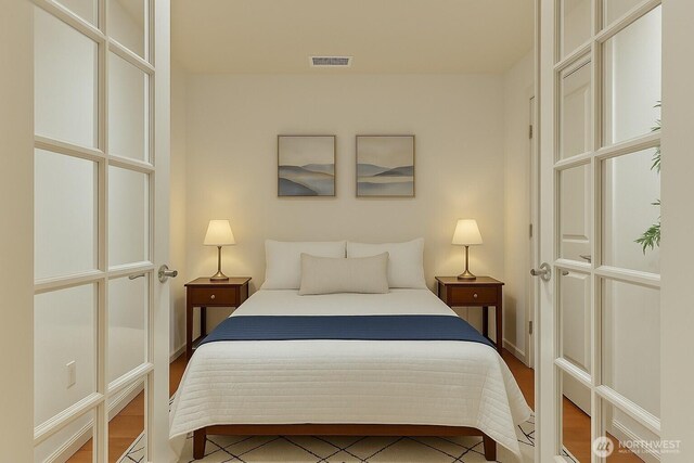 1106 108th Ave NE Unit 503, Bellevue, WA 98004 - bedroom featuring visible vents, baseboards, and wood finished floors