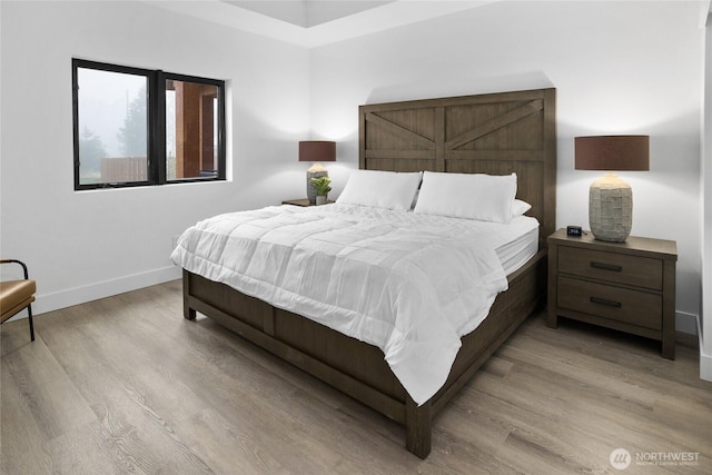 bedroom featuring light wood-style flooring and baseboards