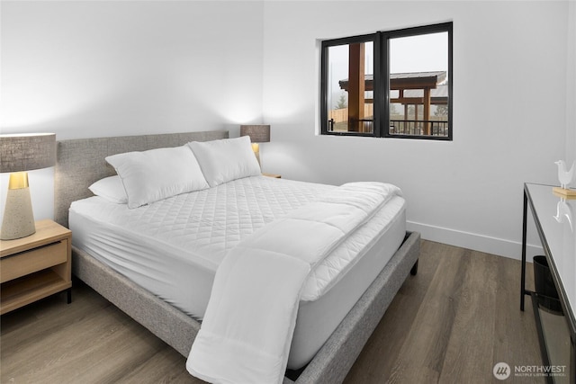 bedroom featuring baseboards and wood finished floors