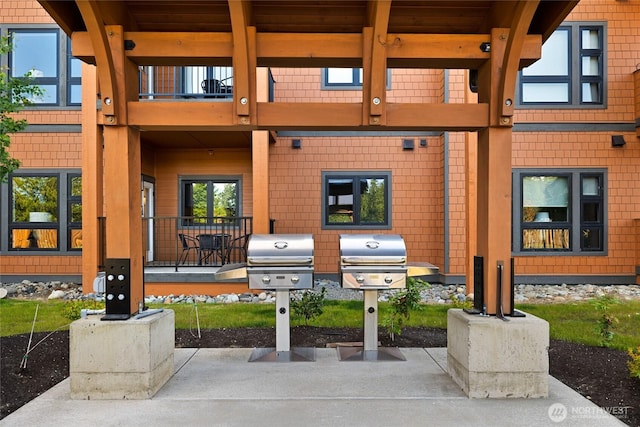 view of patio / terrace with grilling area, a balcony, and mail area