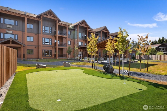 view of home's community featuring fence