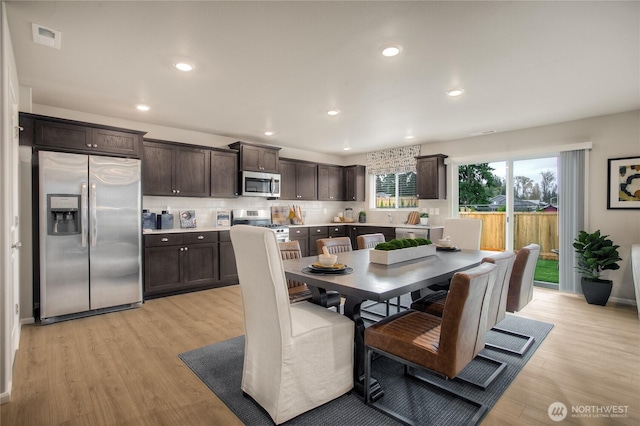 dining room featuring visible vents, recessed lighting, and light wood-style floors