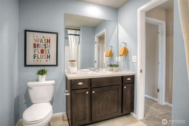 full bath with vanity, toilet, and baseboards