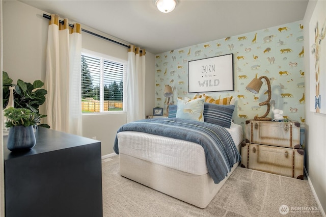 bedroom with wallpapered walls, baseboards, and carpet floors