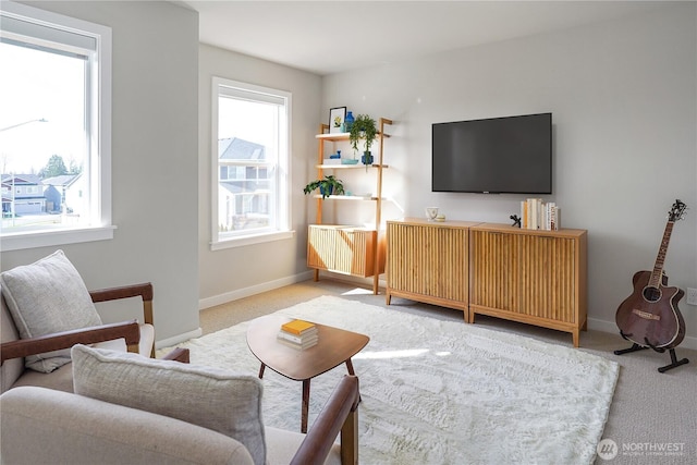 carpeted living room featuring baseboards